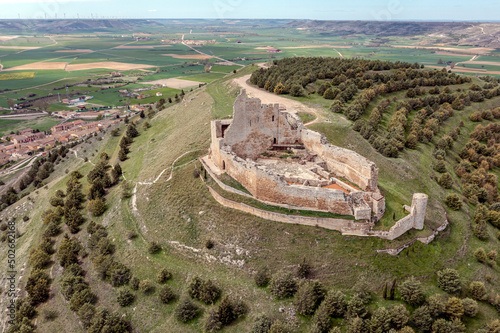 A prominent castle in ruins up on the hill - Castrojeriz, Castile and Leon, Spain photo