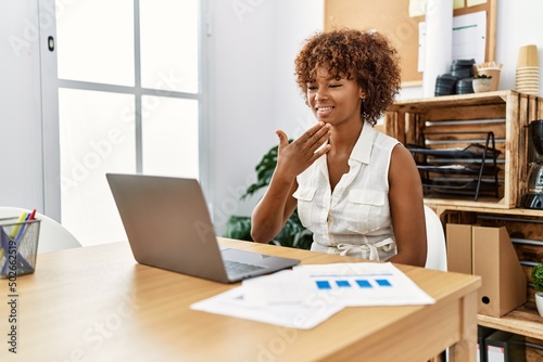 Young african american woman having video call using deaf language at office