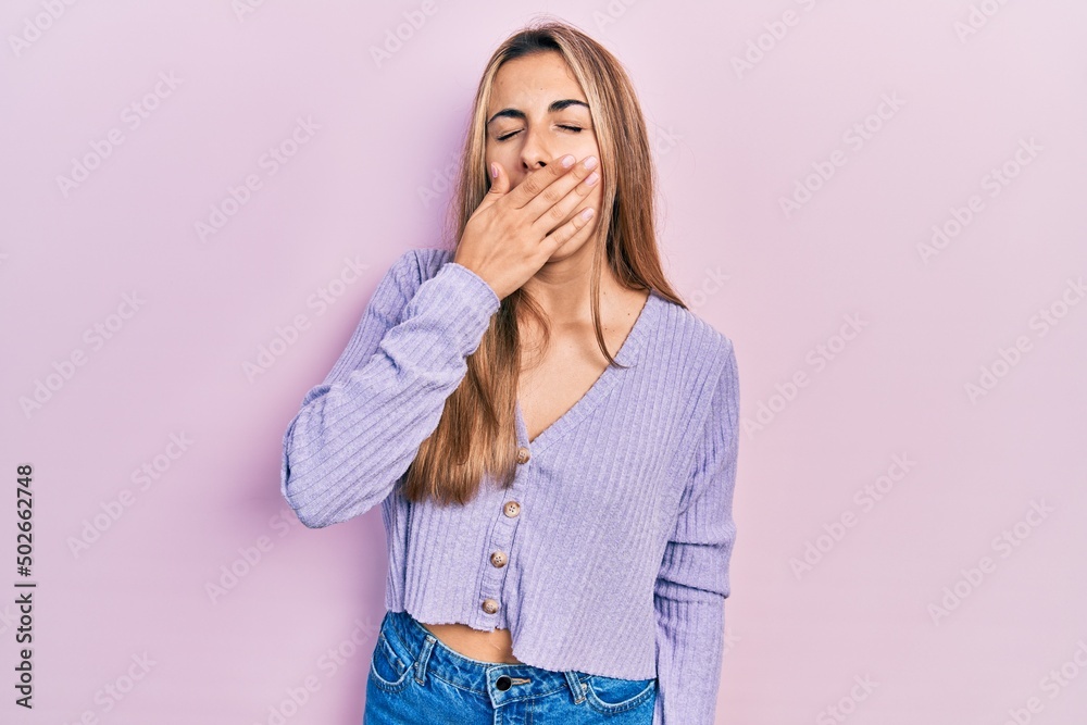 Beautiful hispanic woman wearing casual shirt bored yawning tired covering mouth with hand. restless and sleepiness. Beautiful hispanic woman wearing casual shirt bored yawning tired covering mouth with hand. restless and sleepiness.