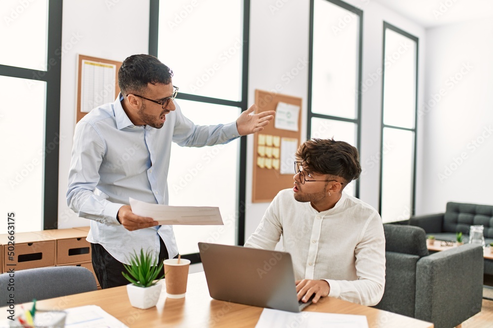Two hispanic men business workers arguing at office Two hispanic men business workers arguing at office