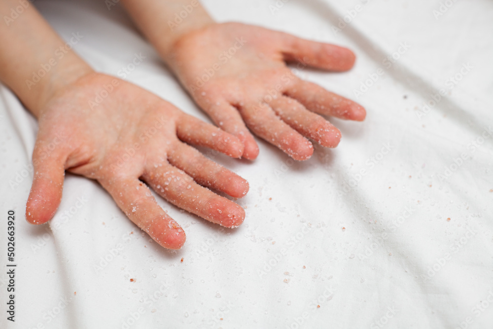 girl on a white sheet doing beauty procedures body scrub girl on a white sheet doing beauty procedures body scrub