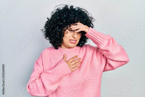 Young middle east woman wearing casual clothes touching forehead for illness and fever, flu and cold, virus sick