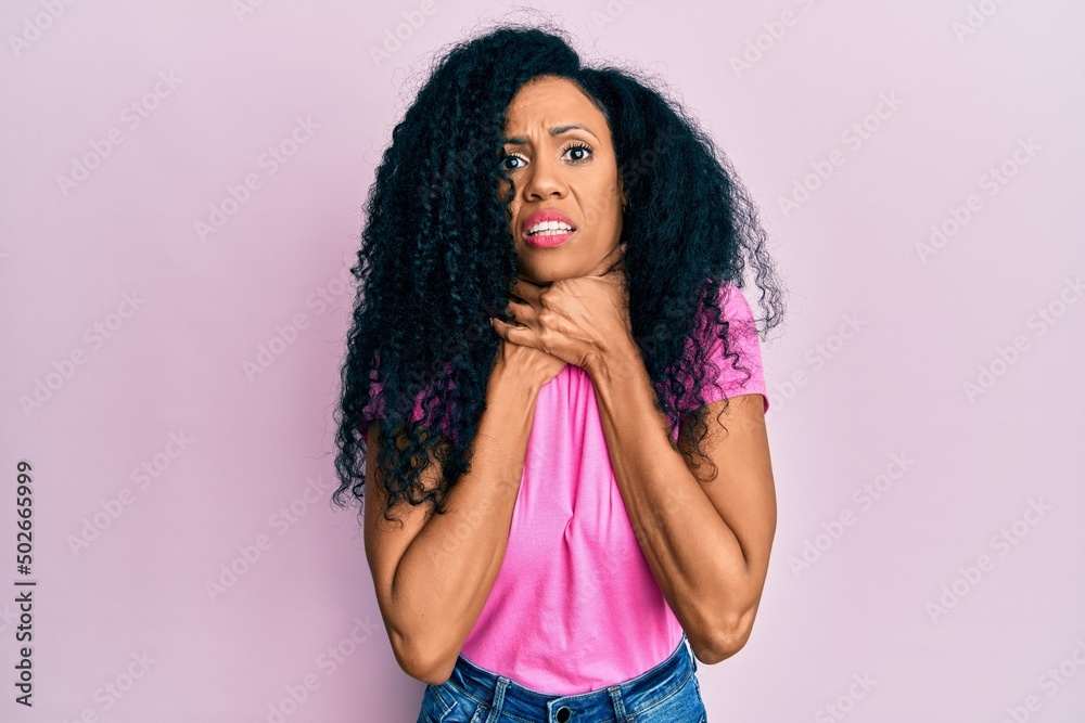 Middle age african american woman wearing casual clothes shouting and suffocate because painful strangle. health problem. asphyxiate and suicide concept. Middle age african american woman wearing casual clothes shouting and suffocate because painful strangle. health problem. asphyxiate and suicide concept.