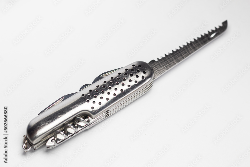 Silver multifunction knife with a wood saw on white background Silver multifunction knife with a wood saw on white background