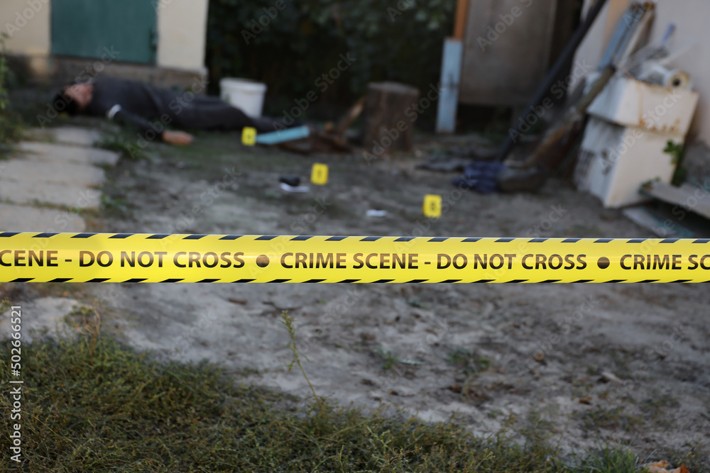 Victim of a violent crime in a backyard of residental house in evening ...