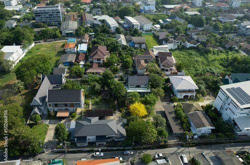 Aerial view of the roof of a house with a car taken by a drone, top view of road © waranyu