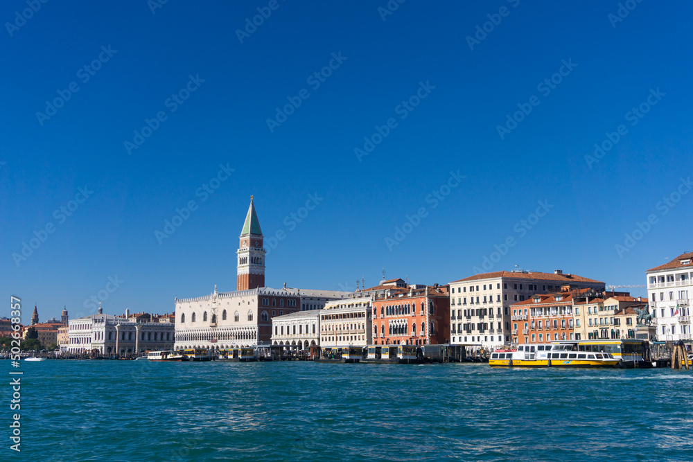 Venice from the water under a clear blue sky