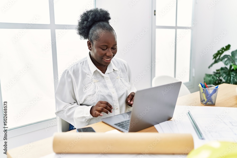 Young african american woman architect having video call at architecture studio Young african american woman architect having video call at architecture studio