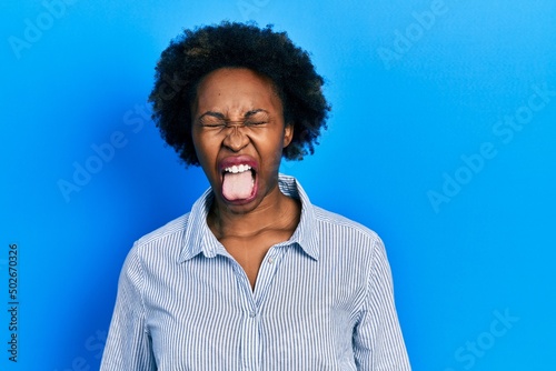 Young african american woman wearing casual clothes sticking tongue out happy with funny expression. emotion concept.