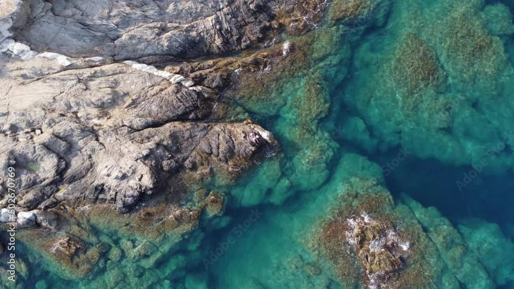 Beautiful aerial view of blue turquoise water breaks on the rocks in Costa Brava, Catalonia, Spain.. High quality 4k footage Beautiful aerial view of blue turquoise water breaks on the rocks in Costa Brava, Catalonia, Spain.. High quality 4k footage