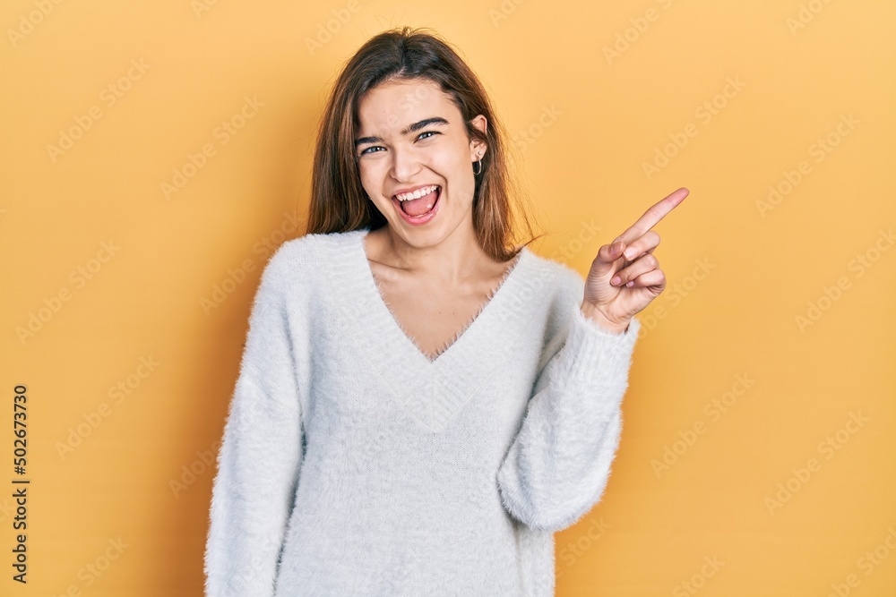 Young caucasian girl wearing casual clothes showing and pointing up with finger number one while smiling confident and happy. Young caucasian girl wearing casual clothes showing and pointing up with finger number one while smiling confident and happy.