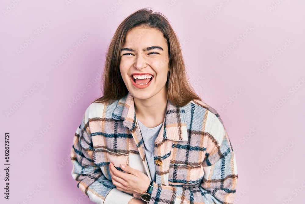 Young caucasian girl wearing casual clothes smiling and laughing hard out loud because funny crazy joke with hands on body. Young caucasian girl wearing casual clothes smiling and laughing hard out loud because funny crazy joke with hands on body.