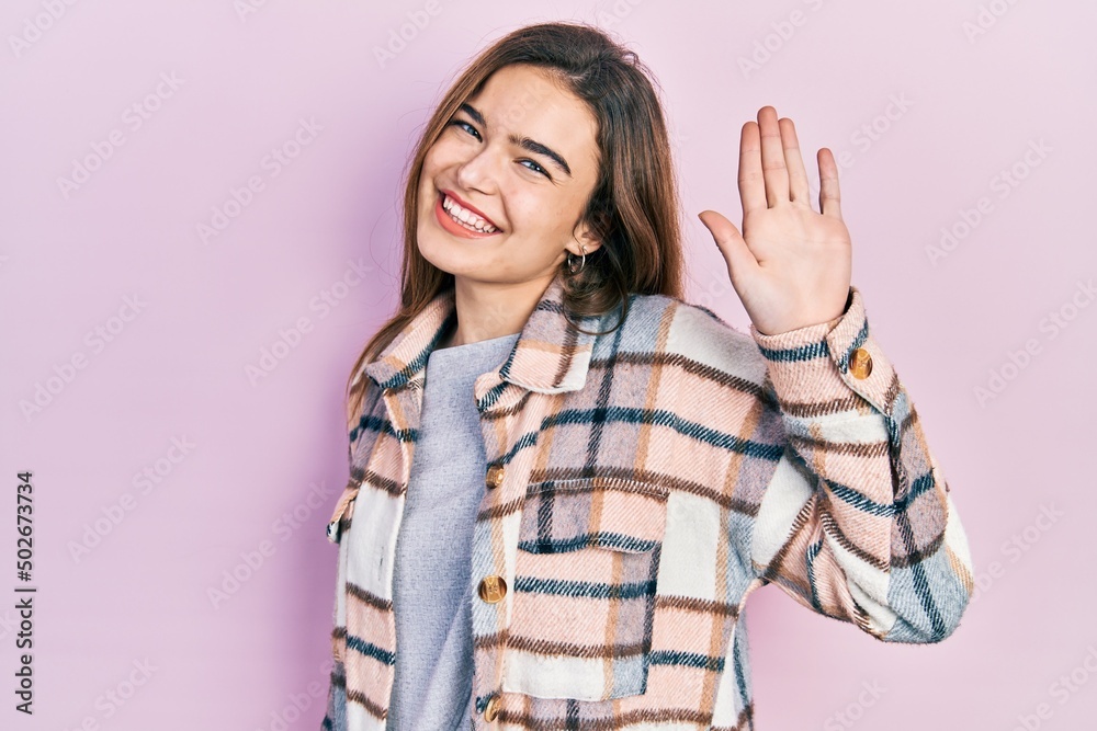 Young caucasian girl wearing casual clothes waiving saying hello happy and smiling, friendly welcome gesture Young caucasian girl wearing casual clothes waiving saying hello happy and smiling, friendly welcome gesture