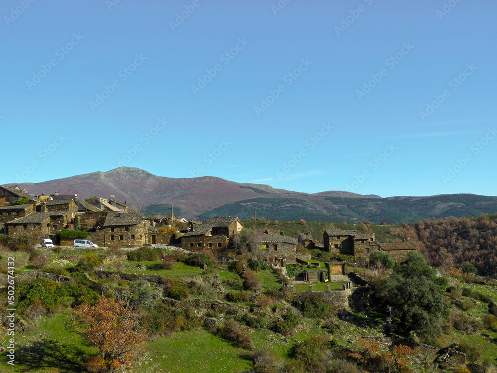 Landscape of the Sierra Norte de Guadalajara, Spain, with a view of the town of black architecture called Roblelacasa