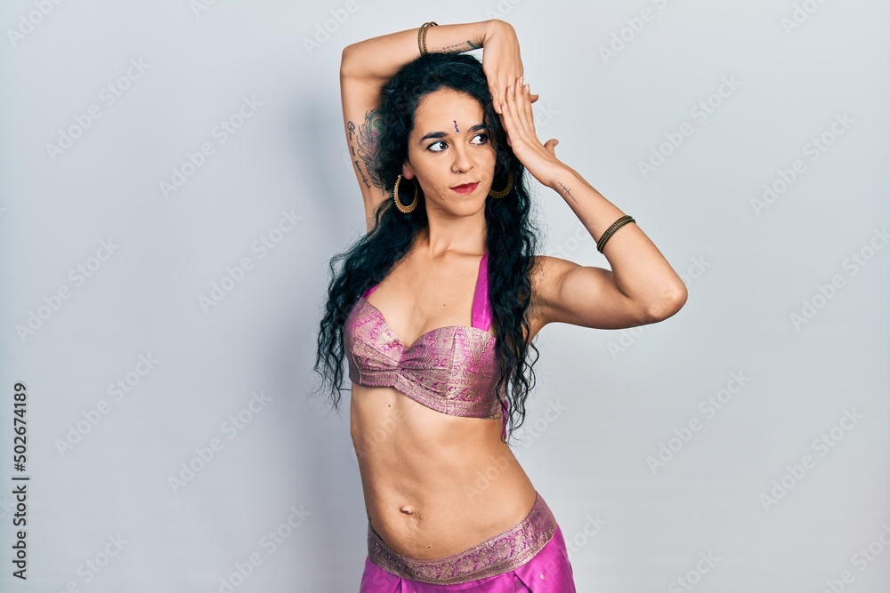 Fototapeta premium Young indian woman wearing traditional belly dancer costume. Dancing exotic oriental dance with body and hands