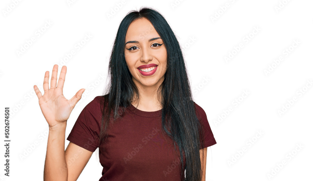 Young hispanic girl wearing casual t shirt showing and pointing up with fingers number five while smiling confident and happy. Young hispanic girl wearing casual t shirt showing and pointing up with fingers number five while smiling confident and happy.