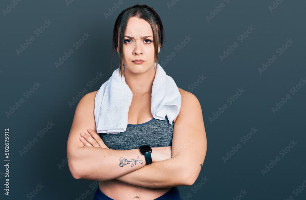 Obraz premium Young hispanic girl wearing sportswear and towel skeptic and nervous, disapproving expression on face with crossed arms. negative person.