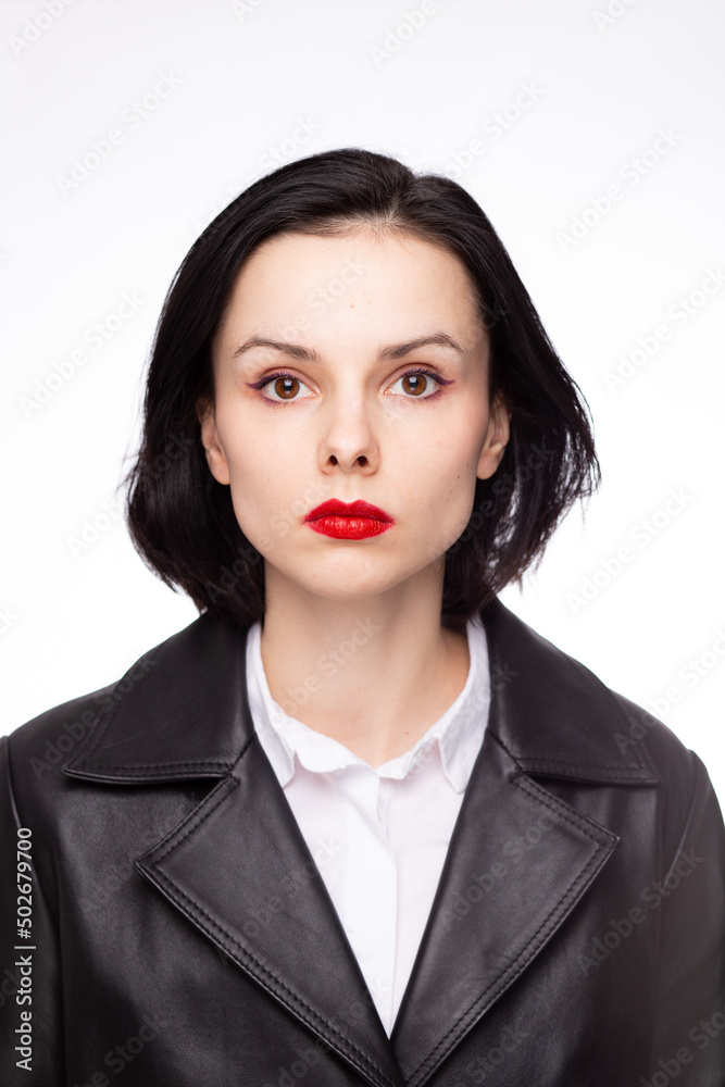 brunette woman with red lipstick on her lips in a black leather jacket and white shirt, white background brunette woman with red lipstick on her lips in a black leather jacket and white shirt, white background