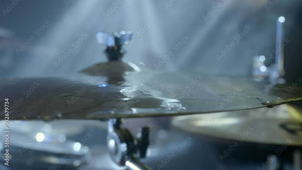 Slow Motion Close-Up Pan Of A Cymbal Being Hit By A Drumstick With Dispersed Water Droplets - Erfurt, Germany Slow Motion Close-Up Pan Of A Cymbal Being Hit By A Drumstick With Dispersed Water Droplets - Erfurt, Germany