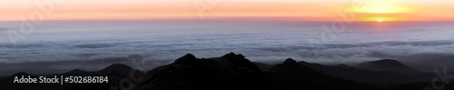 Sun Setting Above the Clouds via CA State Route 35 in Santa Cruz Mountains, California, USA.