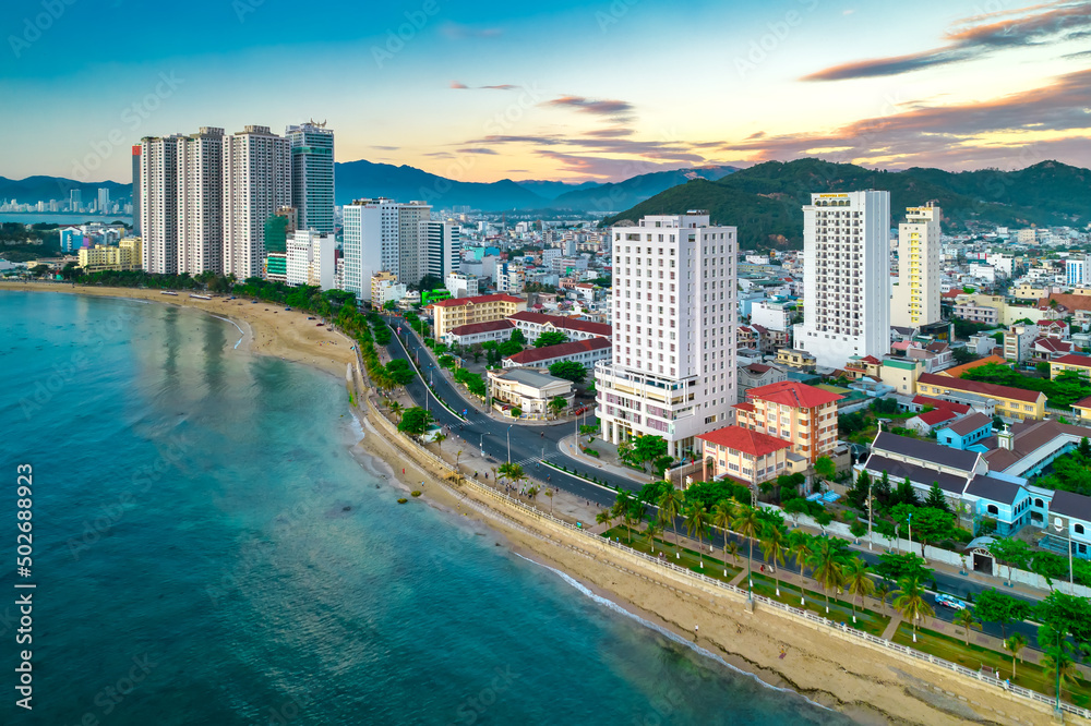 Naklejka premium The coastal city of Nha Trang seen from above in the afternoon with its beautiful city and clean sandy beach attracts tourists to visit in Nha Trang, Vietnam