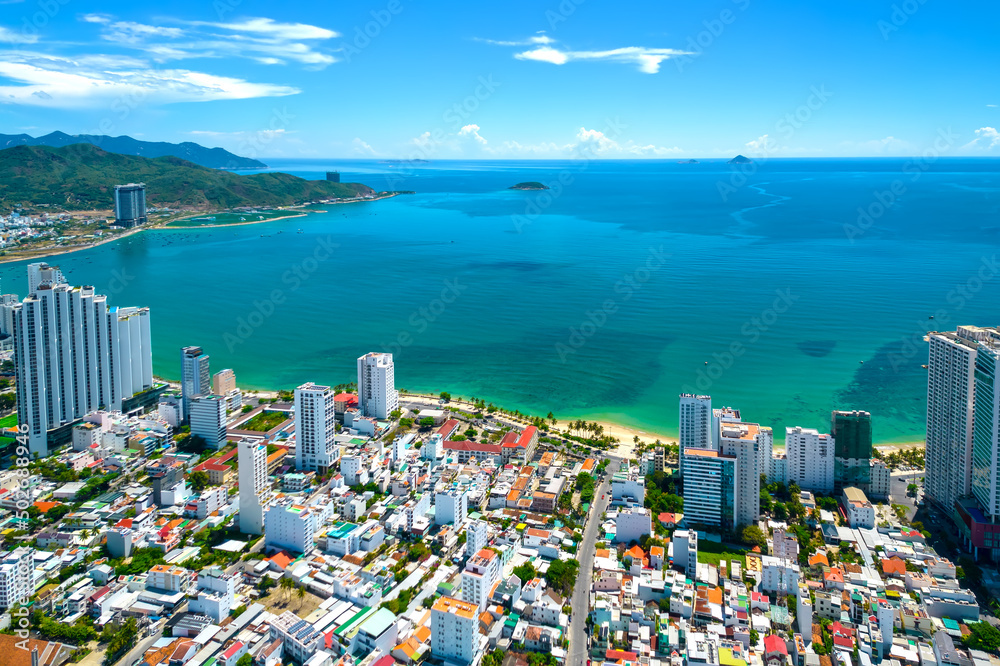 The coastal city of Nha Trang seen from above on a sunny summer afternoon. This is a famous city for cultural tourism in central Vietnam The coastal city of Nha Trang seen from above on a sunny summer afternoon. This is a famous city for cultural tourism in central Vietnam