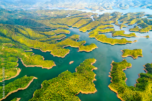 Landscape Ta Dung lake seen from above in the morning with small islands many green trees in succession to create a magnificent beauty. This is the largest hydroelectric lake in Dak Nong, Vietnam