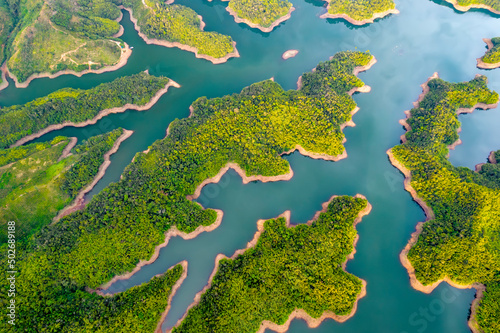 Landscape Ta Dung lake seen from above in the morning with small islands many green trees in succession to create a magnificent beauty. This is the largest hydroelectric lake in Dak Nong, Vietnam © huythoai
