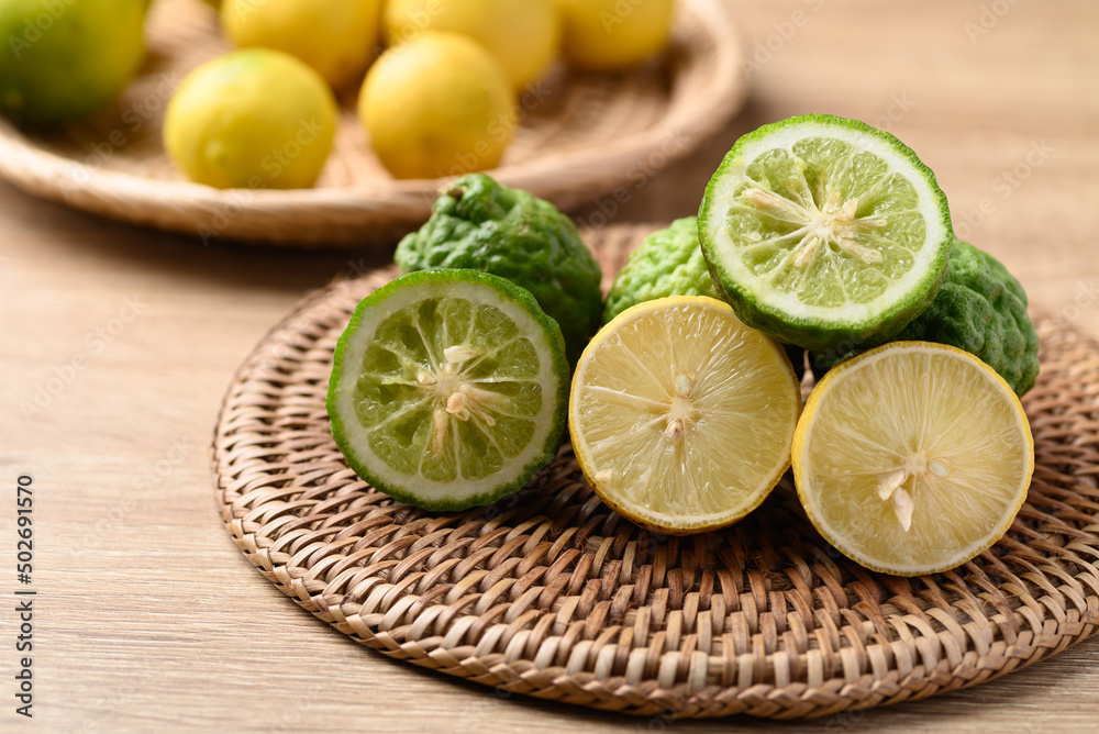 Kaffir lime and yellow lime, Citrus fruit used in Southeast Asian cuisine and essential oil Kaffir lime and yellow lime, Citrus fruit used in Southeast Asian cuisine and essential oil