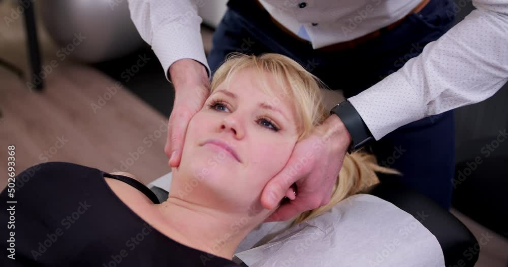 cracking or adjusting the cervical vertebrae by turning the head in a special way by the chiropractor cracking or adjusting the cervical vertebrae by turning the head in a special way by the chiropractor