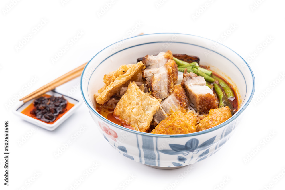 Curry mee or curry laksa is noodle served in curry broth made of cocunut milk, accompanied with roast pork, bean curd, vegetables. Curry mee or curry laksa is noodle served in curry broth made of cocunut milk, accompanied with roast pork, bean curd, vegetables.