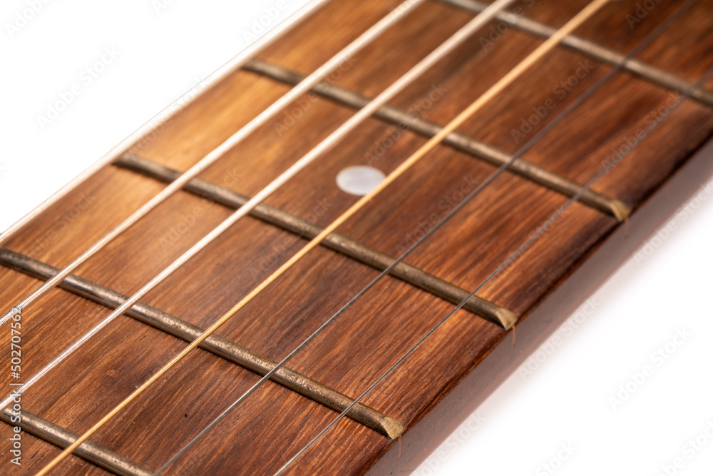 Selective focus, close up guitar neck and guitar strings on white background. Selective focus, close up guitar neck and guitar strings on white background.