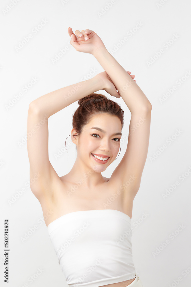 Beautiful Young Asian woman lifting hands up to show off clean and hygienic armpits or underarms on white background, Smooth armpit cleanliness and protection concept Beautiful Young Asian woman lifting hands up to show off clean and hygienic armpits or underarms on white background, Smooth armpit cleanliness and protection concept