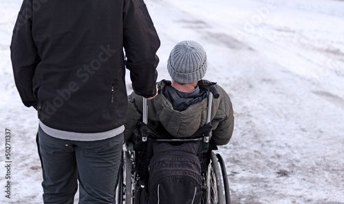 Sundsvall, Norrland Sweden - October 30, 2019: man in wheelchair with companion by his side
