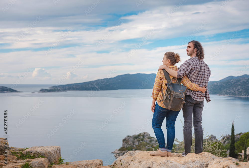 Naklejka premium Couple traveler explore ruins castle of Simena with view of sea bay and Kekova Island with famous flooded city. Tourist attractions in Turkey.