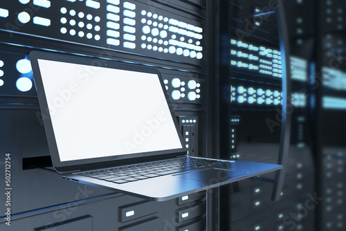 IT solutions concept close up with modern laptop, bright white mockup screen in dark server room with lots of glowing buttons on wallpaper. 3D rendering