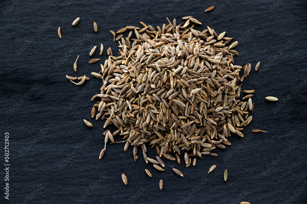 Caraway Seed Pile Top View known as Meridian Fennel and Persian Cumin (Carum Carvi). isolated on black.
