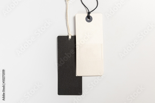 a pair of fashionable blank labels for clothes on a gray background