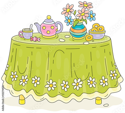 Round kitchen table with a beautiful green tablecloth, a vase with summer flowers and a tea set with tasty bagels in a kitchen at a dacha, vector cartoon illustrations isolated on a white background