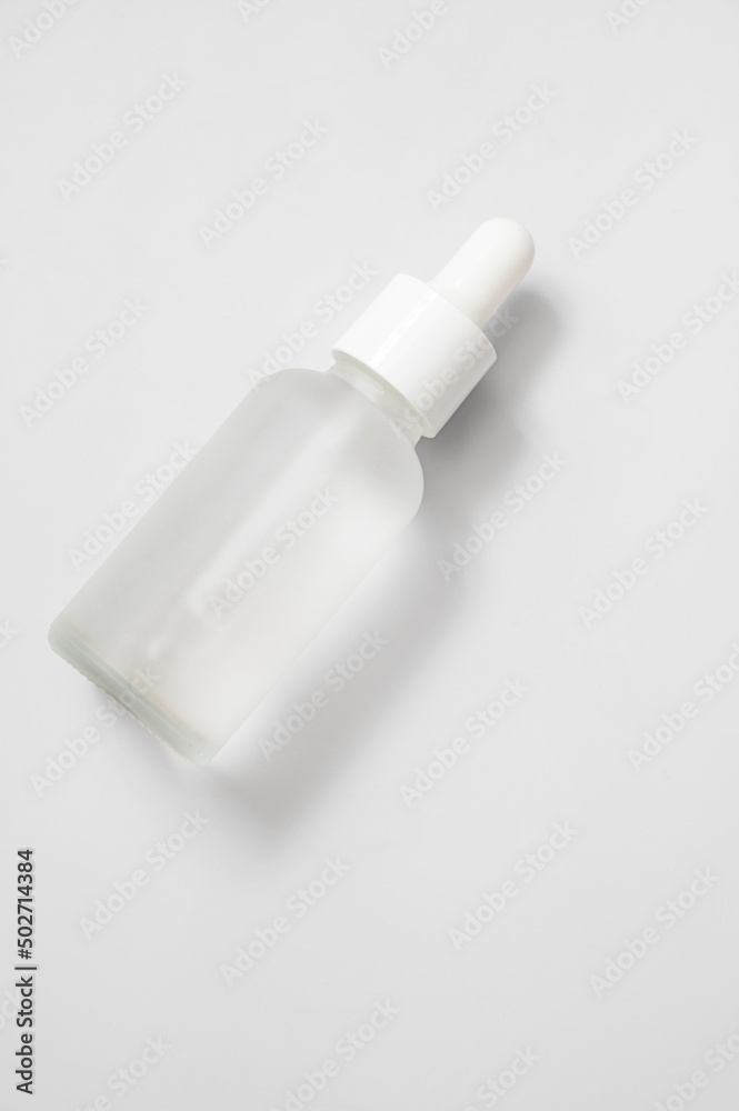Glass matte bottle cosmetic droper on neutral background. Skin care oils, vitamins, collagen. Packaging of cosmetic beauty product, pack shot, copy space Glass matte bottle cosmetic droper on neutral background. Skin care oils, vitamins, collagen. Packaging of cosmetic beauty product, pack shot, copy space