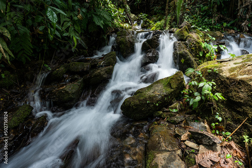 A small beautiful waterfall flowing through black rocks, Ogru water, Ban San Charoen, Nan Province.