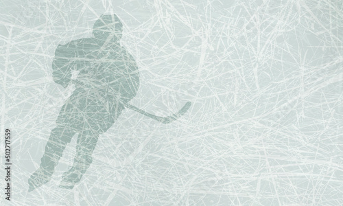 Sports background with a hockey player and a hockey stick in his hands on a light blue ice texture