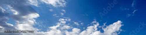 Panoramic photo of blurred sky. Blue sky background with cumulus clouds © supersomik