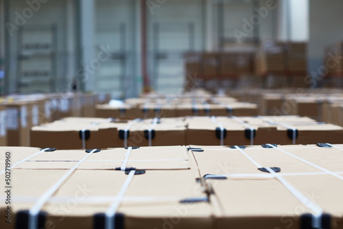 Packaging system. Warehouse inside with shelves, cardboard packages, boxes on a pallet, panorama 