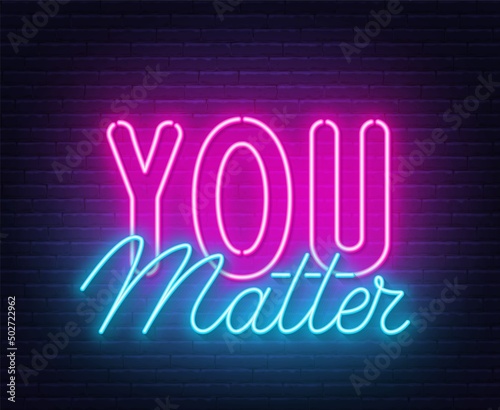 You Matter neon lettering on brick wall background.