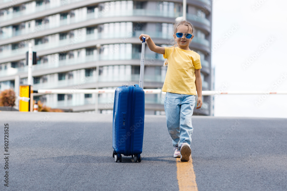 Fototapeta premium cute child with suitcase outdoor