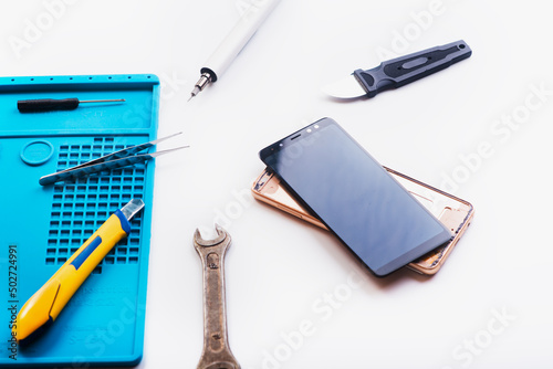 Flat lay image of dismantling the broken smart phone for preparing to repair or replace some components  Top view