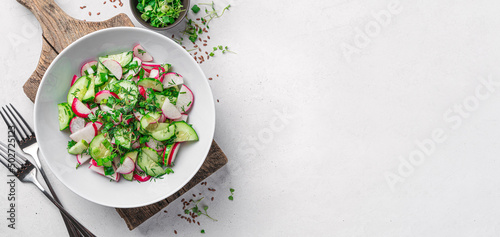 Fotografiet Healthy, summer salad with radish, cucumber, fresh herbs on a light gray background