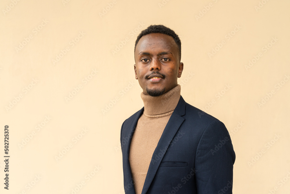 Fototapeta premium Portrait of young handsome black businessman smiling