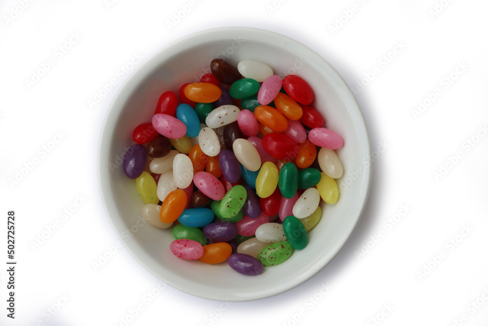 Colorful candies in a white ceramic bowl isolated on white backgrounds Colorful candies in a white ceramic bowl isolated on white backgrounds